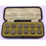 Set of twelve silver buttons, in fitted case