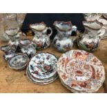 Six graduated Mason's ironstone jugs, three similar plates and a bowl and four other matching dishes