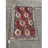 Eastern rug with geometric decoration on blue, red and cream ground, 203cm x 128cm