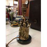 Victorian brass lamp with three putti dressed as Roman centurions, on painted wooden base