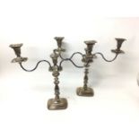 Pair of Georgian style silver plated twin branch candlearbra with gadrooned borders