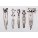 Five silver bookmarks each mounted with a pig, wolf head, bear, baby and pied piper