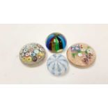 Four Italian glass paperweights, including one with 19 millefiori canes, another with lamp work flow