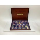 Boxed set of 25 enamel car badges- 'The badges of the world's greatest cars' in presentation box.