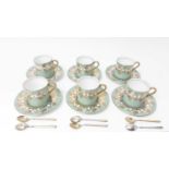 Set of six Aynsley coffee cans and saucers with green and gilt decoration with a set of six silver g