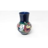 Moorcroft vase with floral decoration on blue ground, impressed marks and blue painted signature to