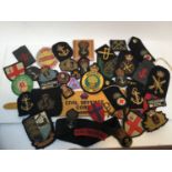 Collection of Royal Navy and other British military cloth badges including a Civil Defence Corps War