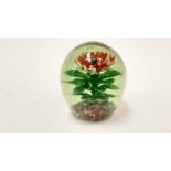 Large pale green glass doorstop / paperweight encasing a rising single lampwork flower and leaves, 1