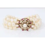 Three strand cultured pearl bracelet with gold gem set flower clasp