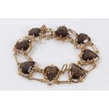 9ct gold smoky quartz bracelet with eight heart shaped smoky quartz, interspaced with long oval link