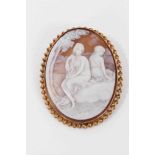Carved shell cameo depicting two seated female figures, in 9ct gold brooch mount