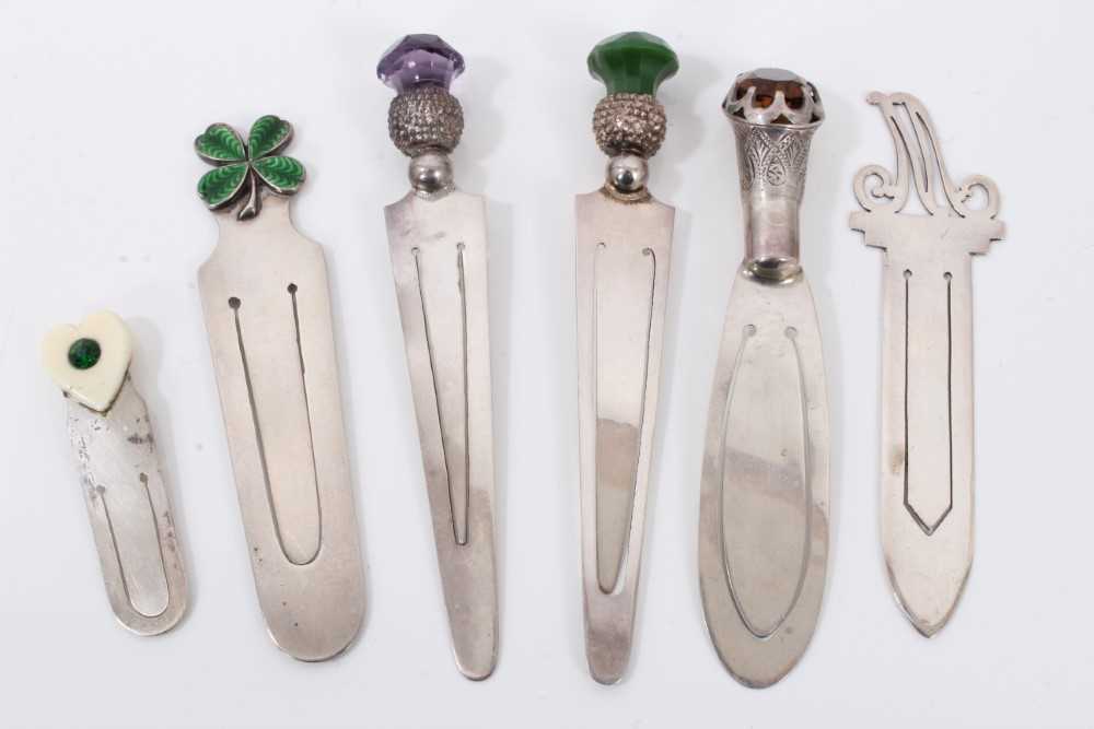 Six silver bookmarks to include three mounted with stones, enamelled shamrock, gem set heart and let
