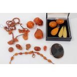 Group of loose amber beads, two amber pendants, pair clip on earrings, oval agate panel etc