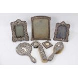 Group of five silver photograph frames, brushes and mirror
