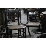 Four Regency brass inlaid dining chairs with caned seats on sabre legs and another Regency chair on