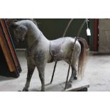 19th century child's polychrome painted wooden push along horse, with sledge base on castors, 74cm l