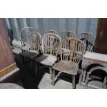 Six 19th century elm Windsor hoop back kitchen chairs with crinoline stretchers and Windsor elbow ch
