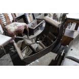 Unusual Regency toleware sleigh-shaped crib with scroll canopy and floral rosettes and nine toleware