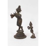 Antique bronze figure of Lord Krishna, 22cm high, together with another smaller. (2)