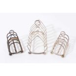 Pair 1920s small silver four division toast racks of hooped form, and one other (3)