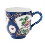 A Worcester large coffee or chocolate cup, painted with exotic birds, on a powder blue ground, circa