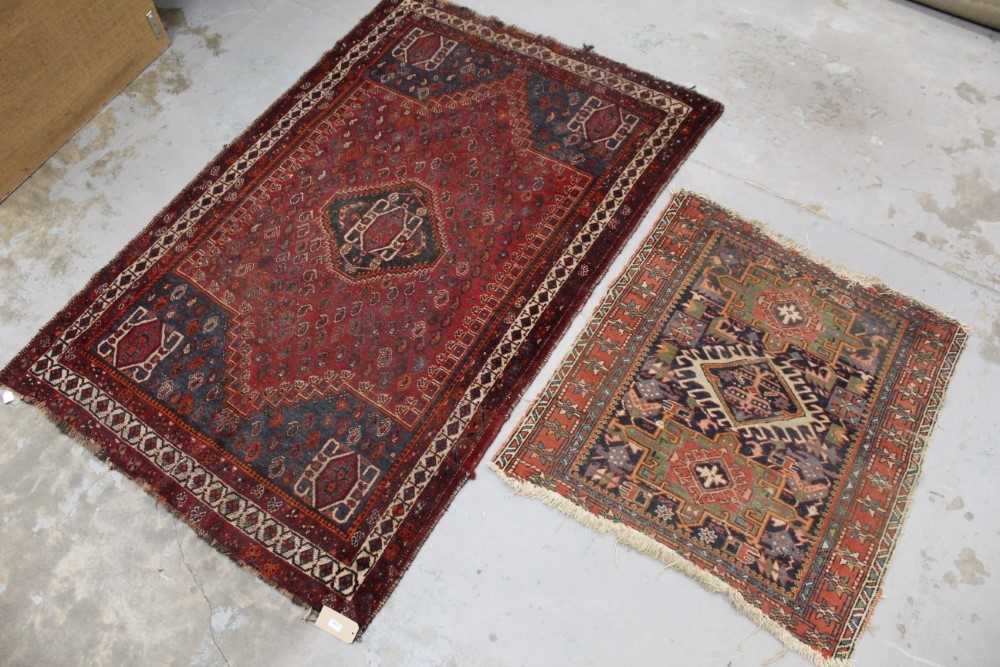 Persian rug, together with a small Heriz rug