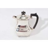 1930s silver coffee pot of shaped baluster form, with angular ebony handle and hinged domed cover,