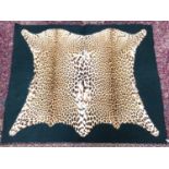 Early 20th century Leopard skin rug with green felt backing