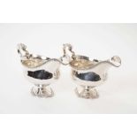 Pair of George III silver sauce boats with gadrooned edging and scroll handles on pedestal bases