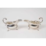 Pair Edwardian silver sauce boats of conventional form, on lion mask paw feet