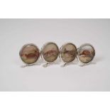 Set of four 1920s silver mounted menu holders, each decorated with a picture of a gamebird