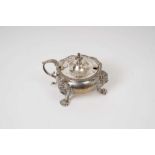 George V silver mustard pot of cauldron form, with gadrooned border, leaf mounted scroll handle