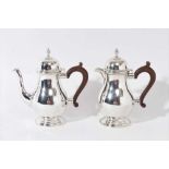 George III style silver coffee pot and hot milk jug of baluster form, London 1938