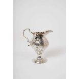 George III silver cream jug of baluster form, with raised swag decoration
