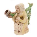 Prattware figure, circa 1810, in the form of Martha Gunn smoking a large pipe, with a serpent form h