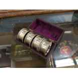 Set of four Victorian silver napkin rings with engraved engine turned decoration and vacant cartouch