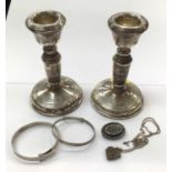 Pair of silver dwarf candlesticks, together with a group of silver jewellery
