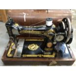 Ornate gilded Singer sewing machine, Serial No. Y841467, in wooden case