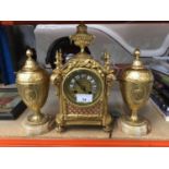DecorativeFrench gilt metal mantle clock , key and pendulum present and pair vases and covers
