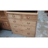 Antique pine chest of two short and three long drawers with brass handles