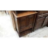 Small oak cupboard with pair of panelled doors with carved linen fold decoration above single draw.