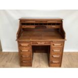 Early 20th century oak roll top desk with tambour shutter and seven drawers below, 106cm wide, 68cm