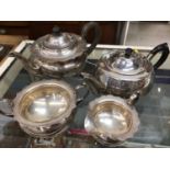Silver plated three piece tea set and one other teapot