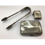 Pair of silver fiddle pattern sugar tongs, together with a silver cigarette case and silver vesta ca