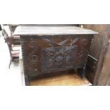 Antique oak miniature coffer with rising lid and carved front on shaped end standards