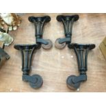 Set of four 19th century cast iron and lignum vitae castors of large proportions