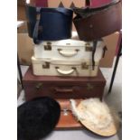 Three vintage suitcases, Pakawa briefcase and two vintage hat boxes each containing a hat