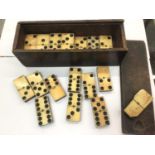Set of 19th century bone and ebony dominoes in original wooden box