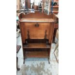 Edwardian oak escritoire with fall front and open shelves below, 64.5cm wide, 24cm deep, 119cm high