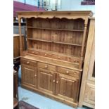 Large pine two height dresser with open shelves and four short drawers above, three drawers and thre